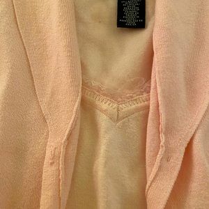 Pale pink sweater set with lace trim.
